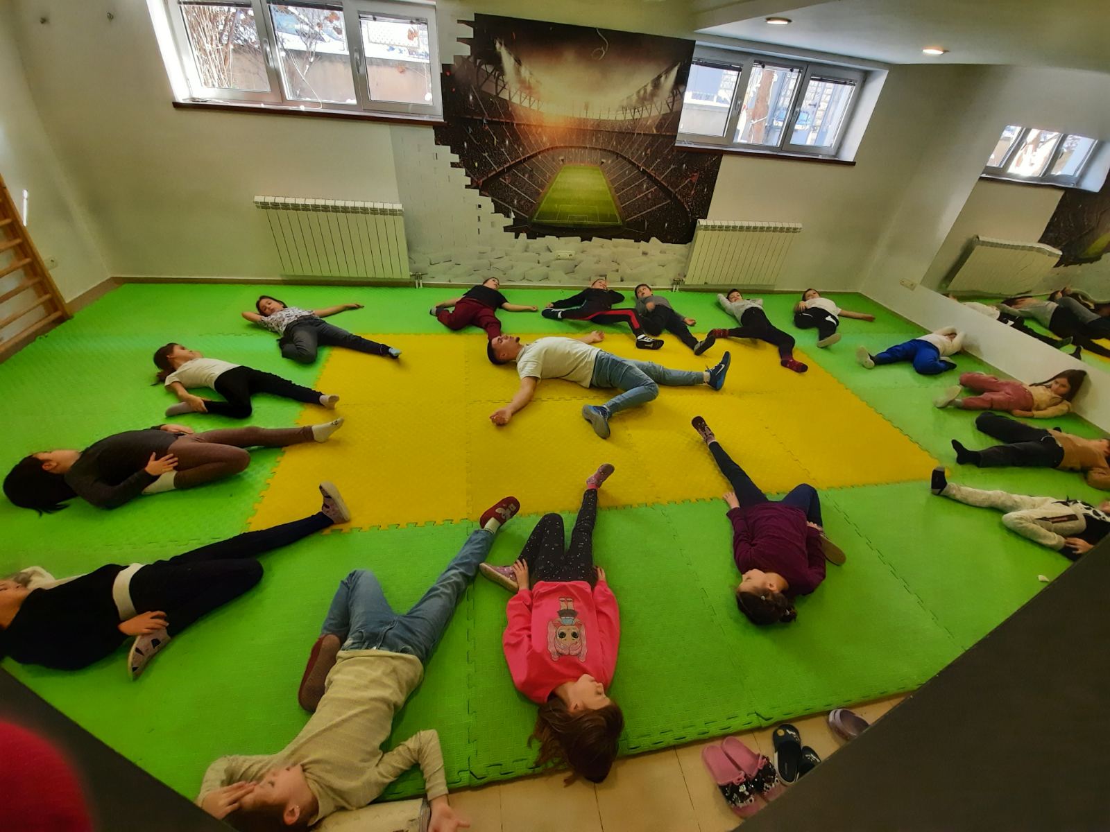 Osnovci u fiskulturnoj sali rade vežbe istezanja